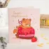 Открытка на 2 шоколадки Самой очаровательной (мишка на торте)